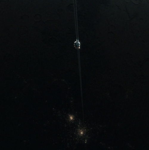 A view of a space elevator connecting an orbital platform to the Raymer Industrial Complex on New Gibson